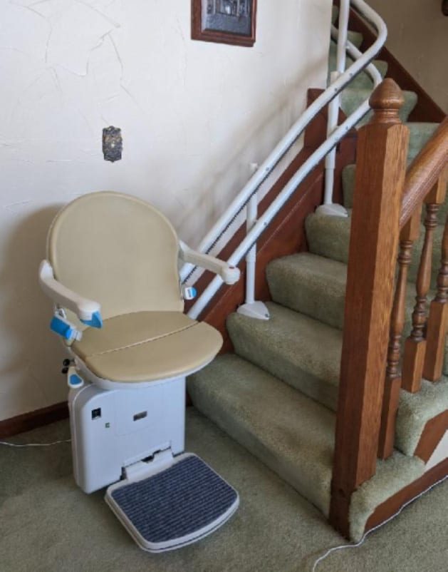 Handicare 2000 stairlift waiting at the bottom of the steps